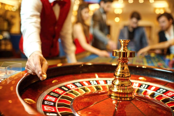 Live dealer at French Roulette table with multi-camera studio setup